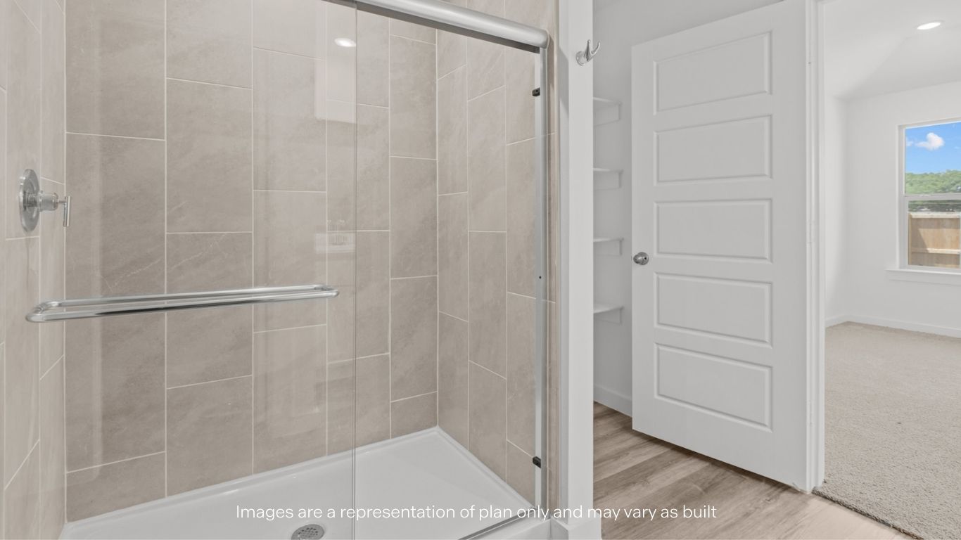 Private attached primary bathroom with built in vanity and luxurious shower