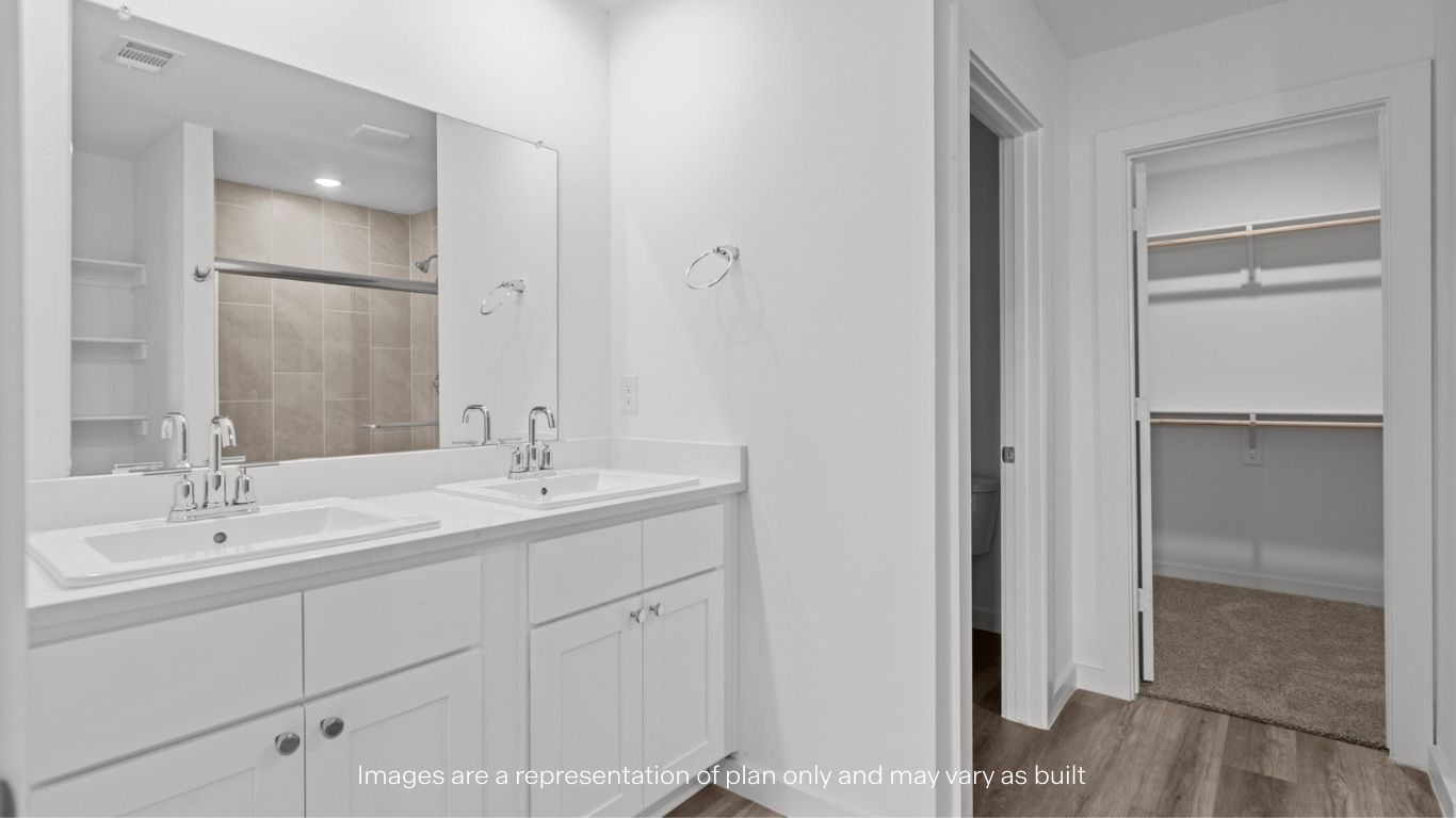 Private attached primary bathroom with built in vanity and luxurious shower
