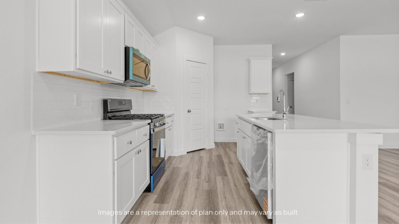 Open concept kitchen with stainless steel appliances, shaker style cabinets, and elevated finishes