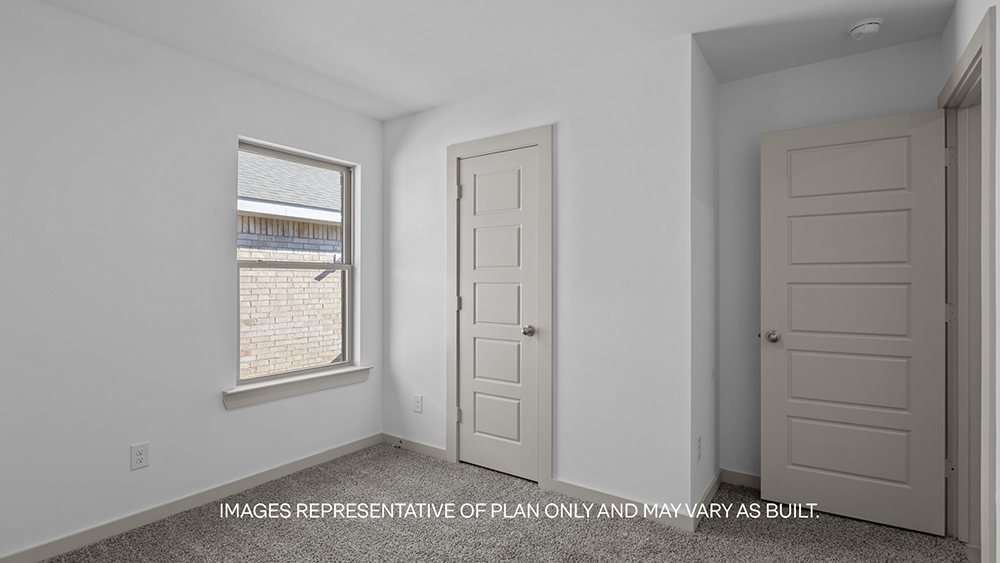 Guest bedroom 2 with side window and plush carpet floor