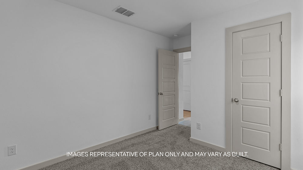 Guest bedroom 1 with plush carpet floors and spacious closet