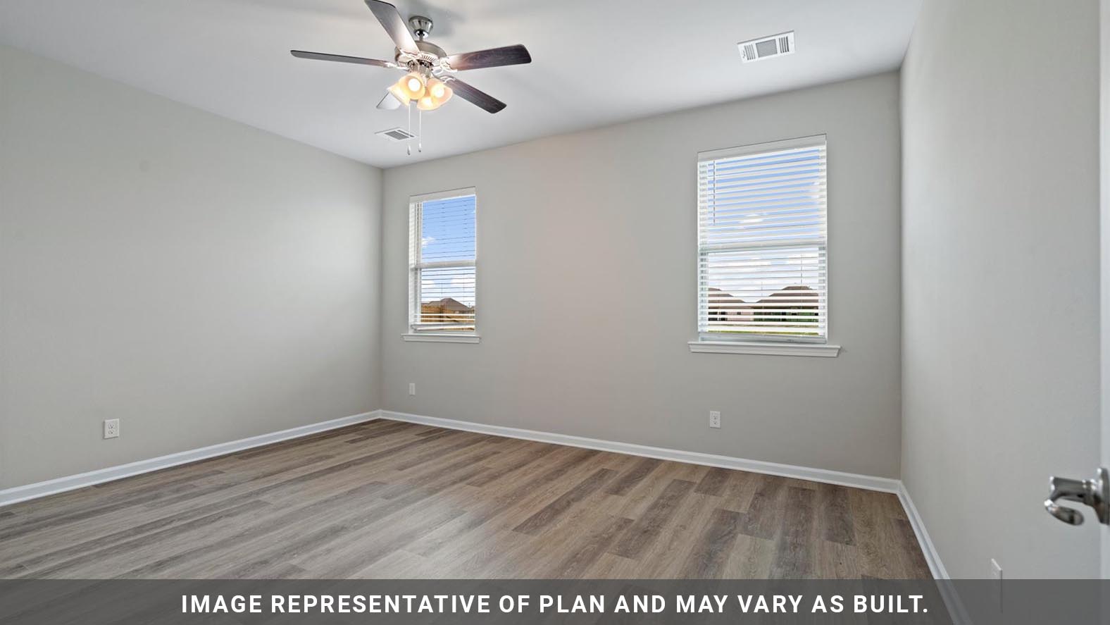 Primary bedroom with plush carpet floors and light allowing double windows