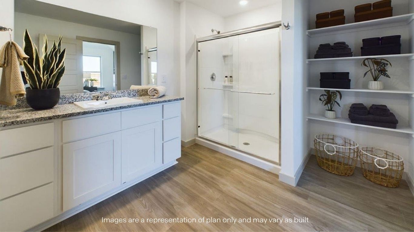 Private attached primary bathroom with built in vanity and luxurious shower