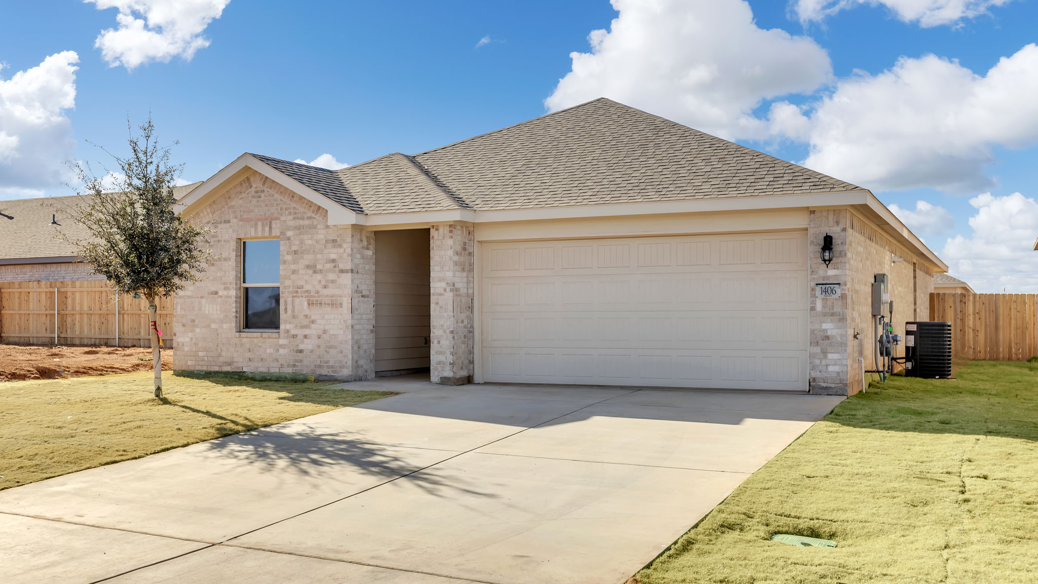 Single- story home with brick, stone, covered patio and two car garage