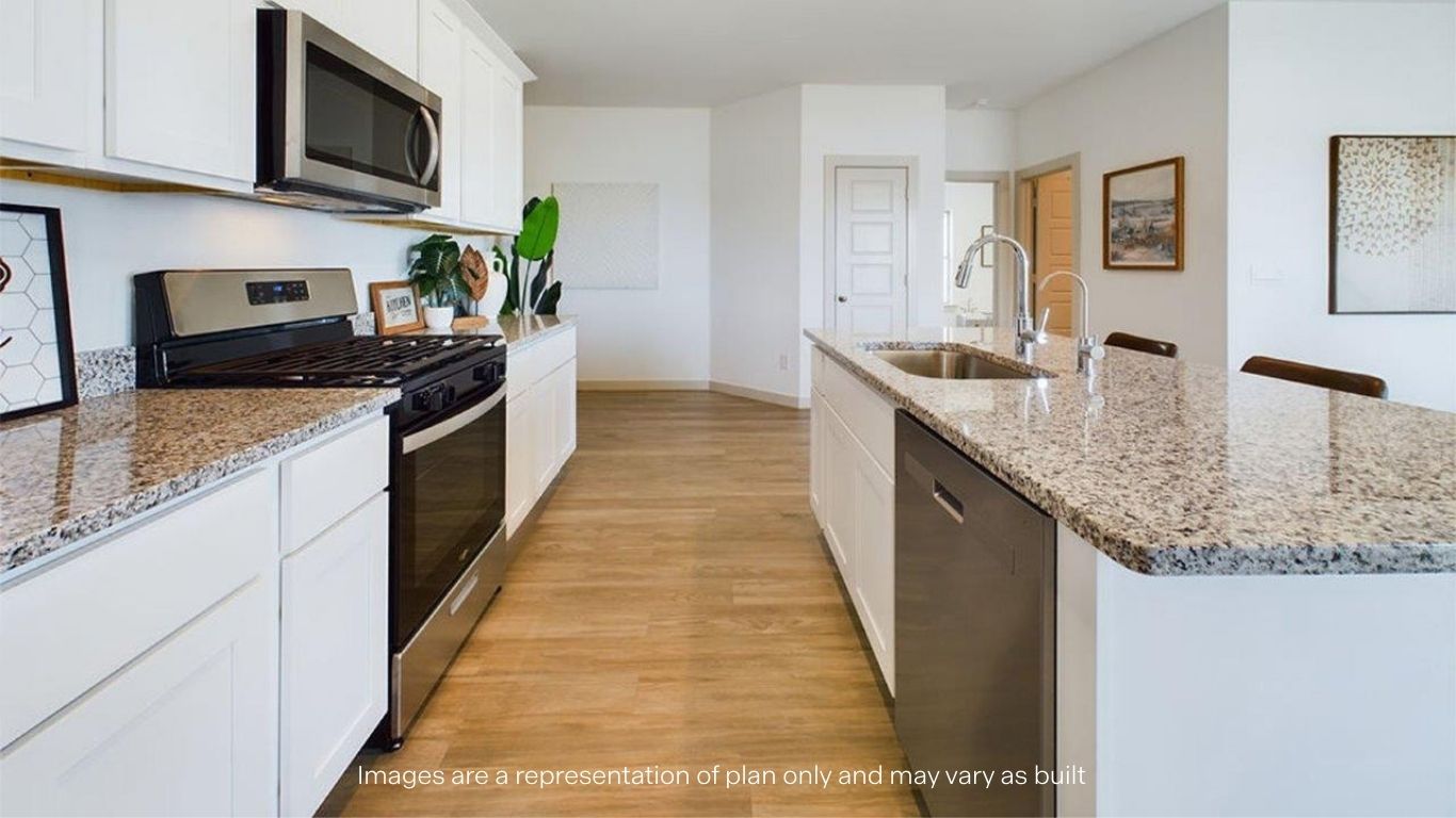 Open concept kitchen with stainless steel appliances, shaker style cabinets, and elevated finishes