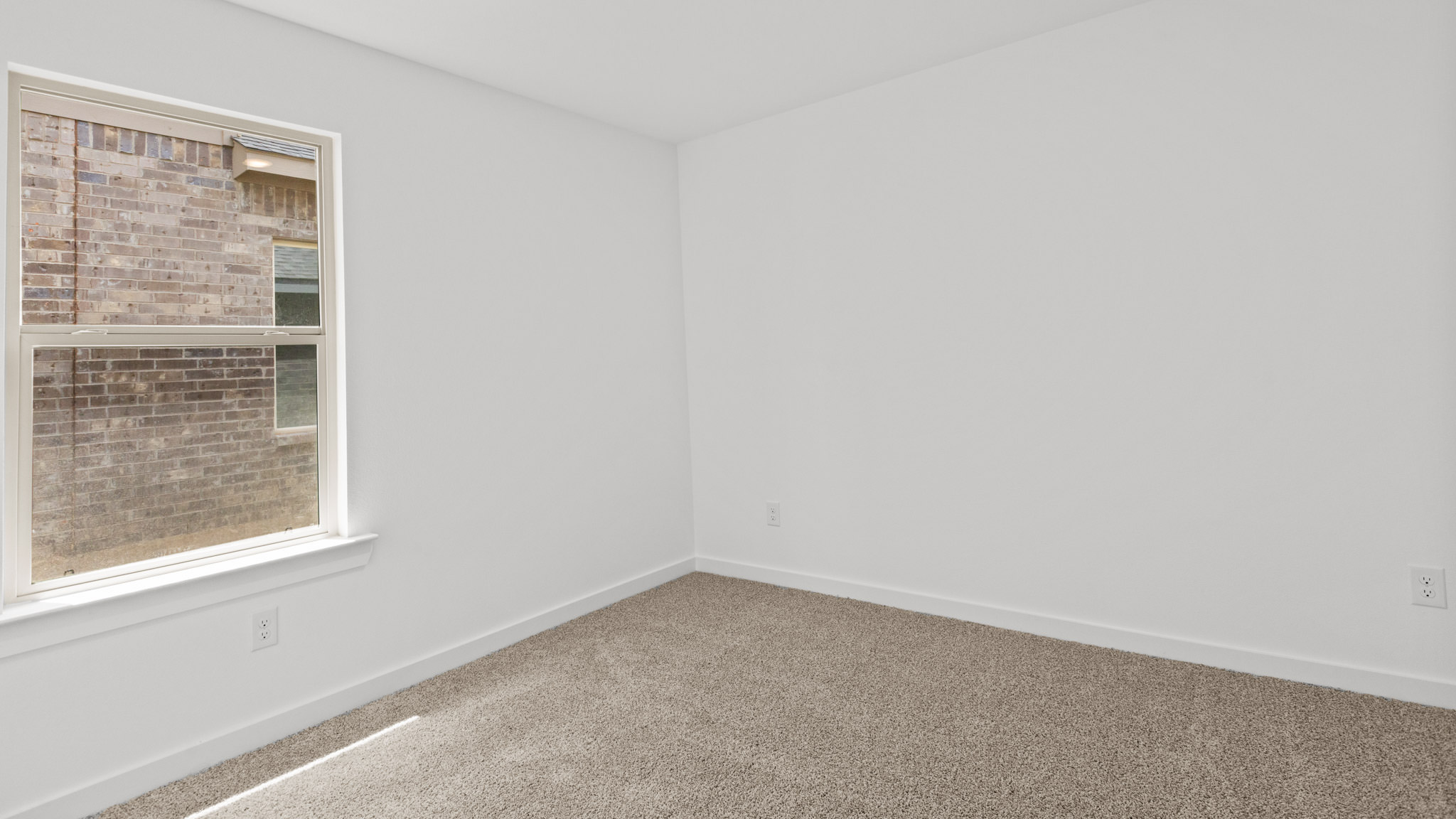 guest bedroom with plush carpet and spacious closet