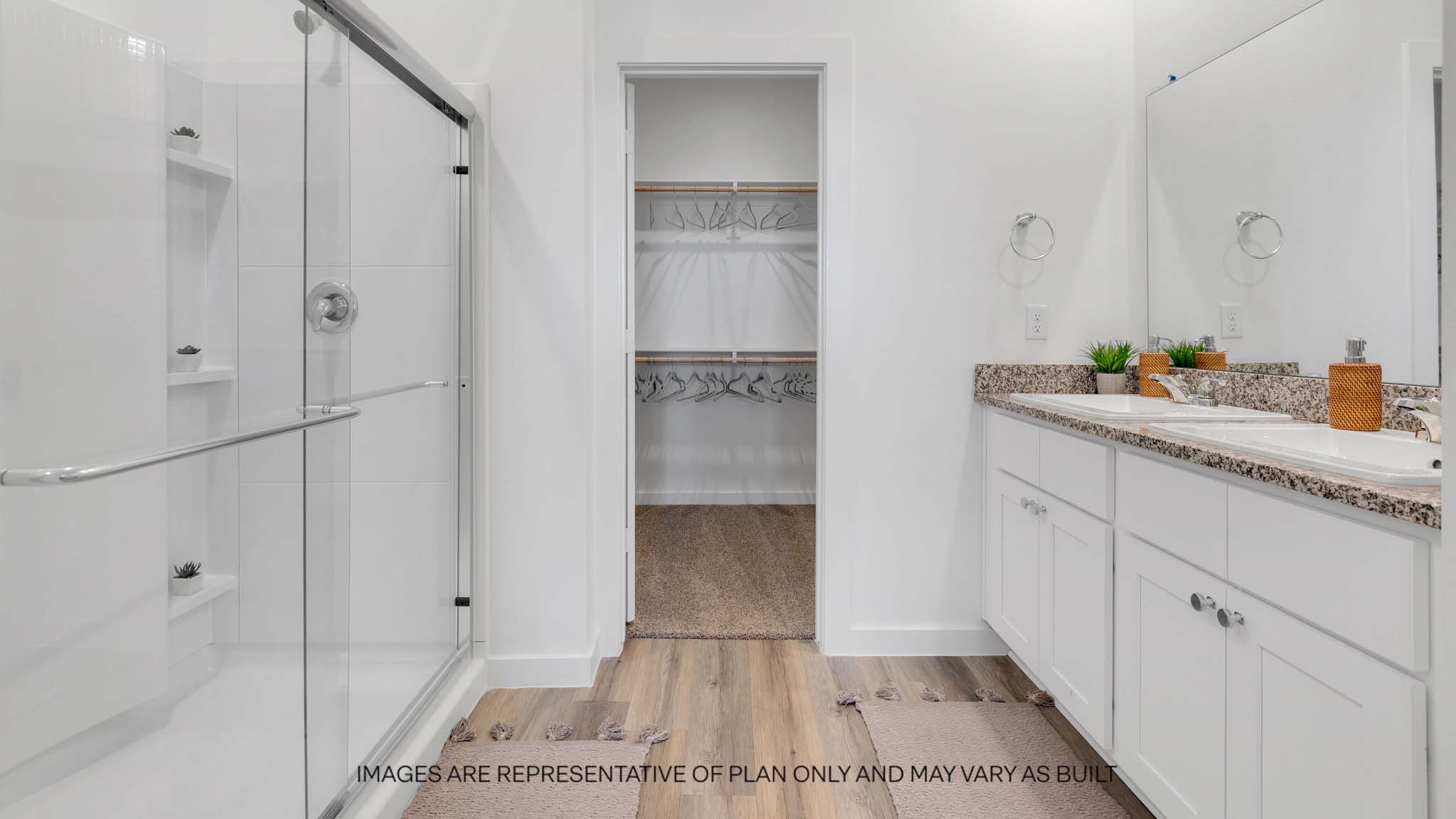 Private attached primary bathroom with built in vanity and luxurious shower