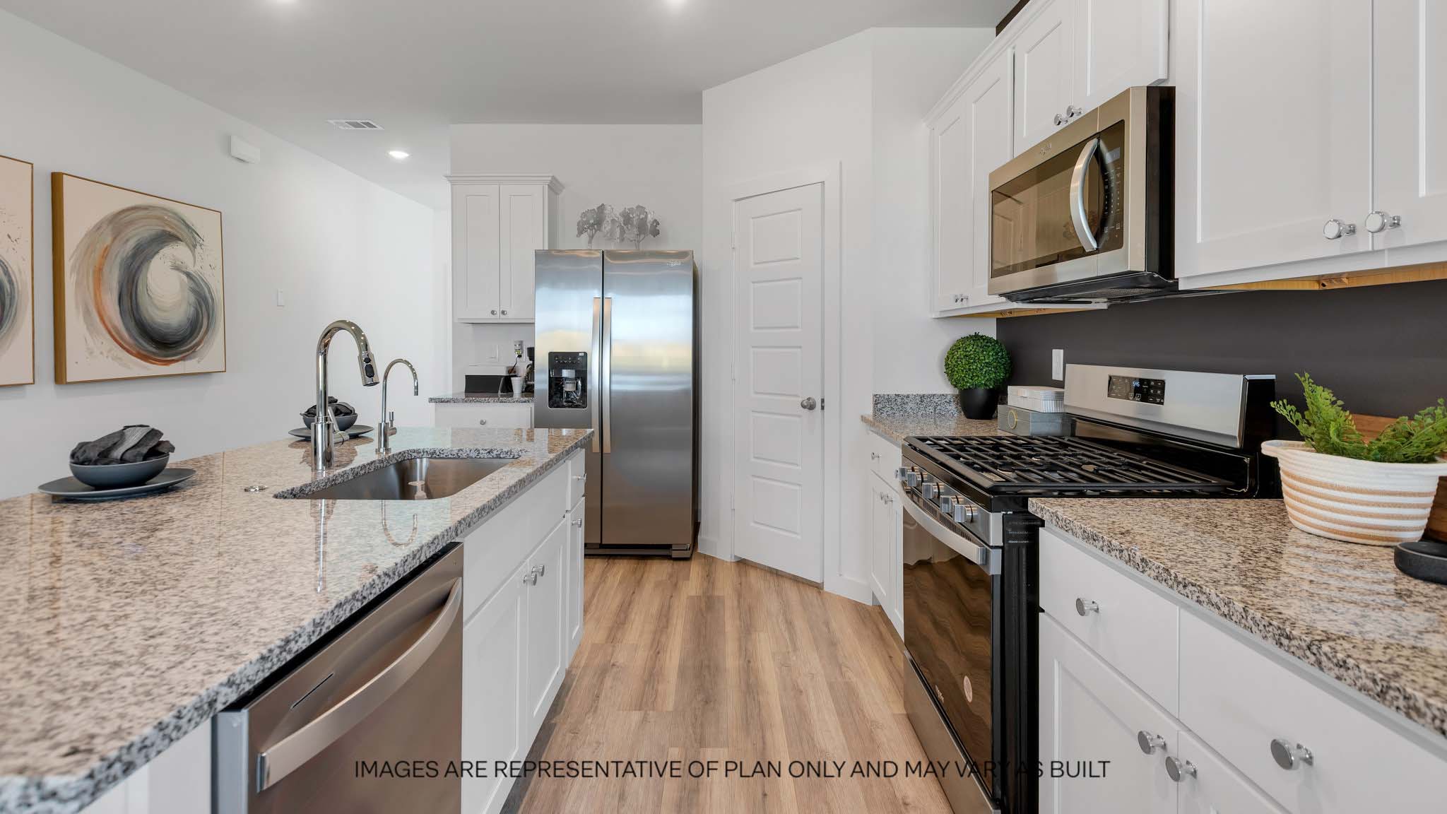Open concept kitchen with stainless steel appliances, shaker style cabinets, and elevated finishes