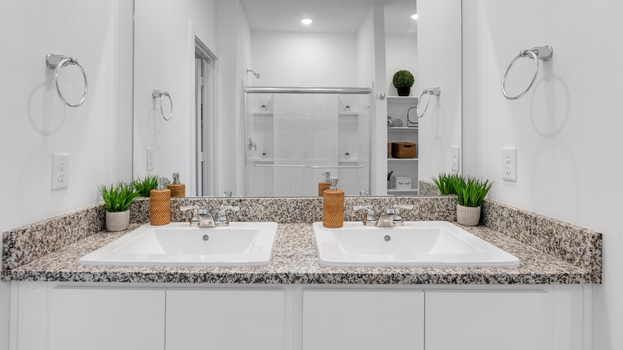 Private attached primary bathroom with built in vanity and luxurious shower