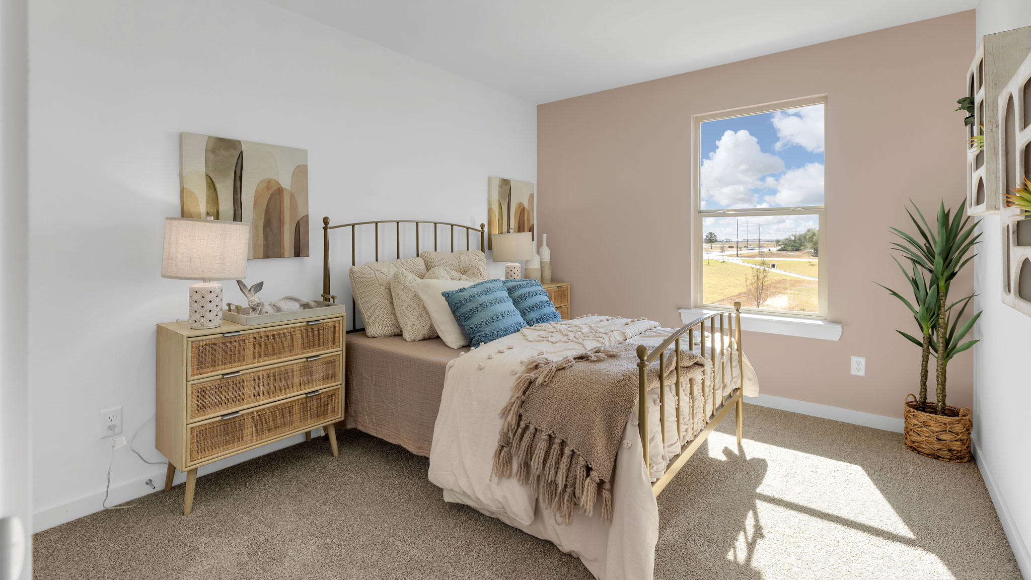 Upstairs guest bedroom with plush carpeted floors and ample natural light