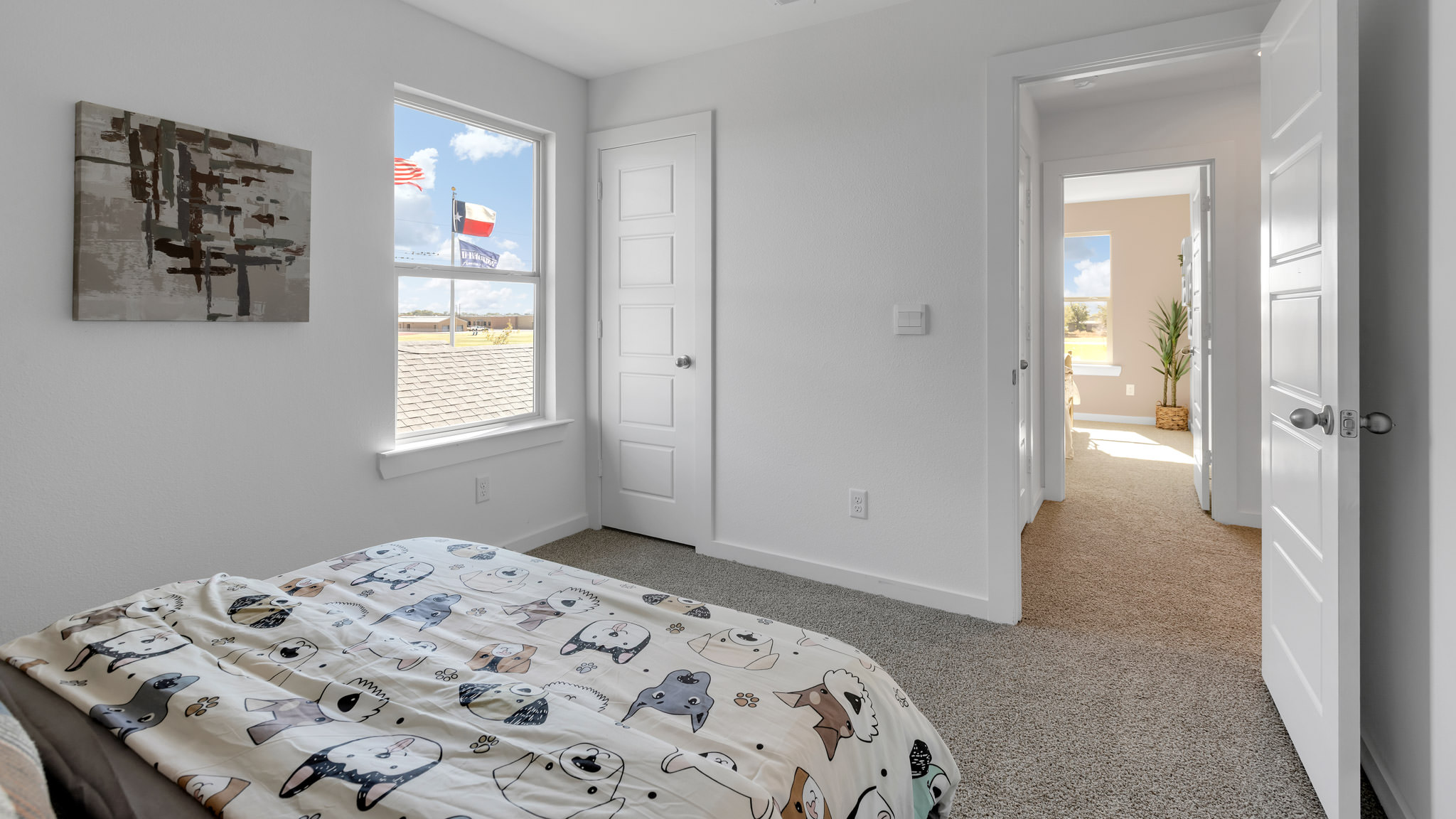 Upstairs guest bedroom with plush carpet floors and spacious closet