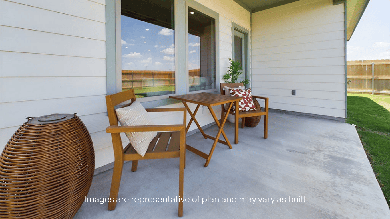 Covered back patio area overlooking spacious backyard