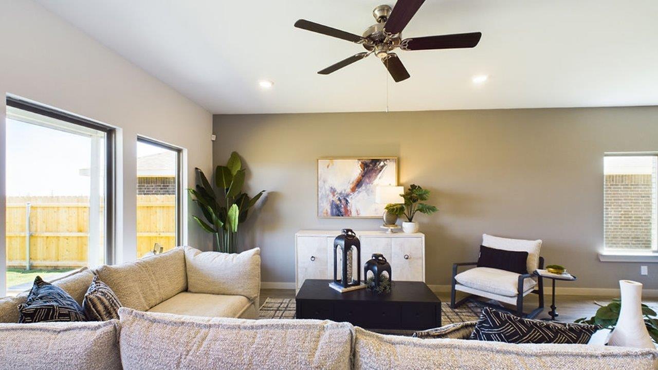 Living room has large bright windows