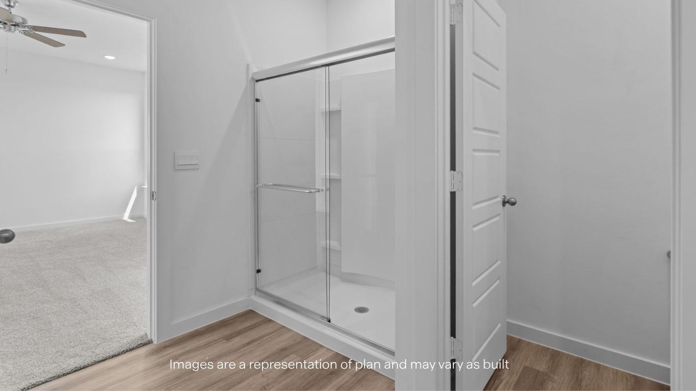 Private attached primary bathroom with built in vanity and luxurious shower