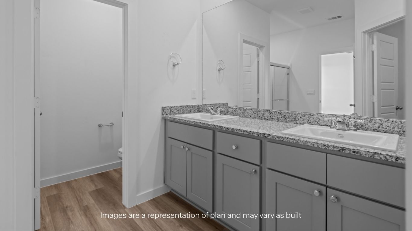 Private attached primary bathroom with built in vanity and luxurious shower