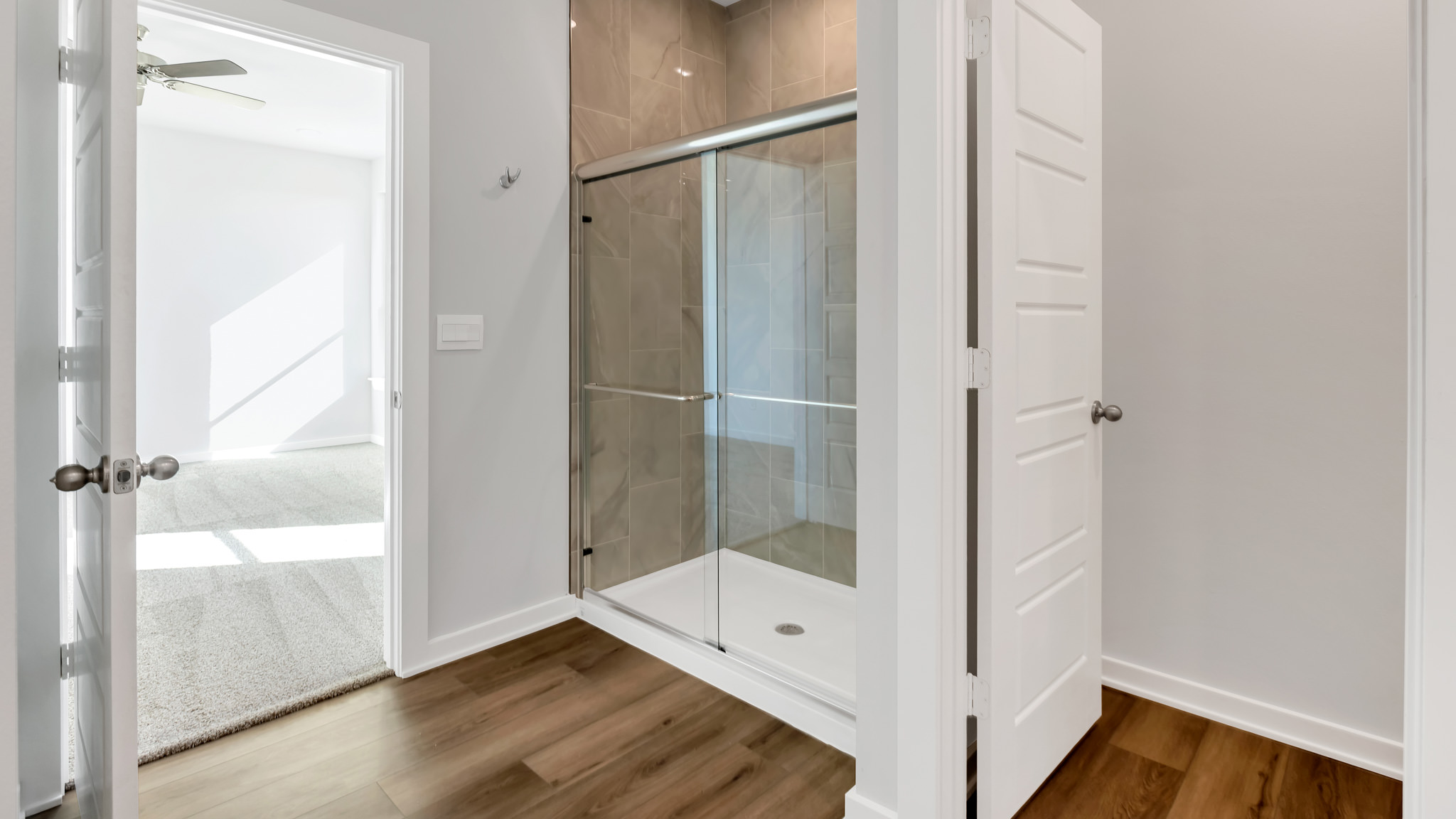 Primary bathroom with built in vanity and luxurious shower