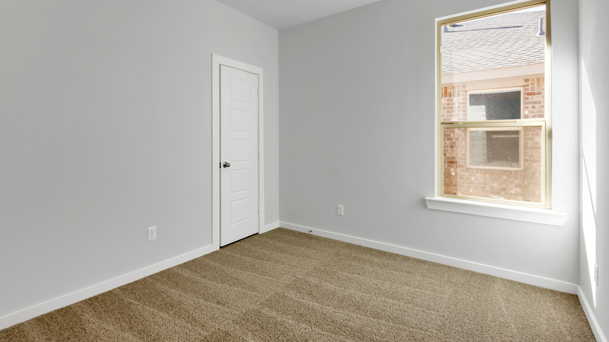 Guest bedroom 2 with side window and plush carpet floor
