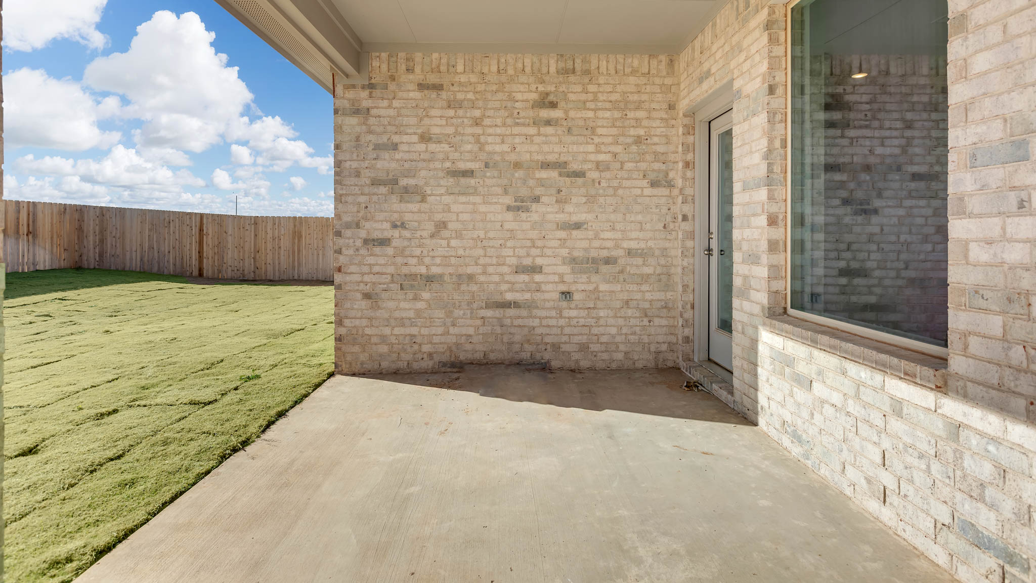 Covered patio area overlooking backyard