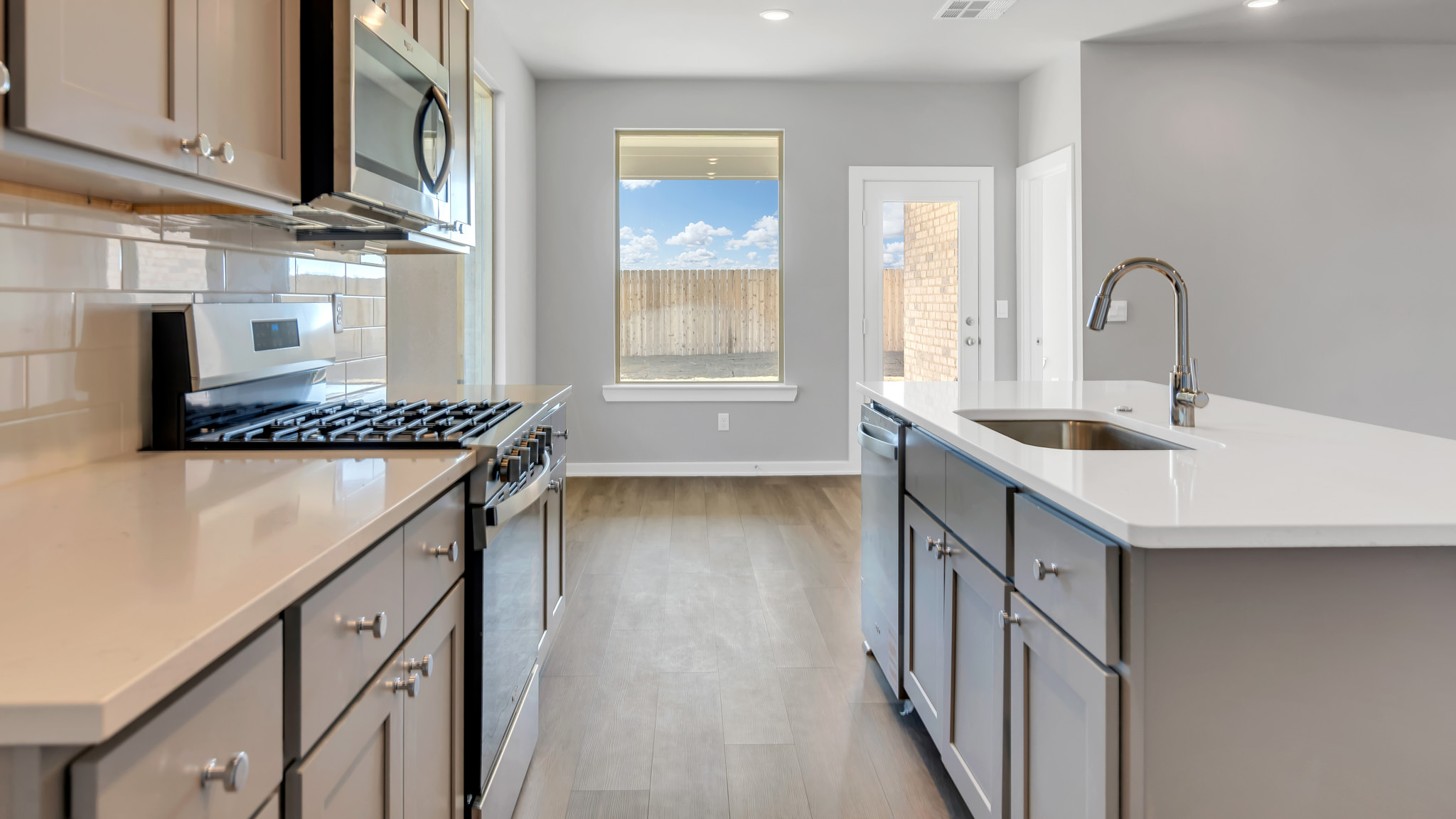 Modern kitchen with stainless steel appliances and shaker style cabinets
