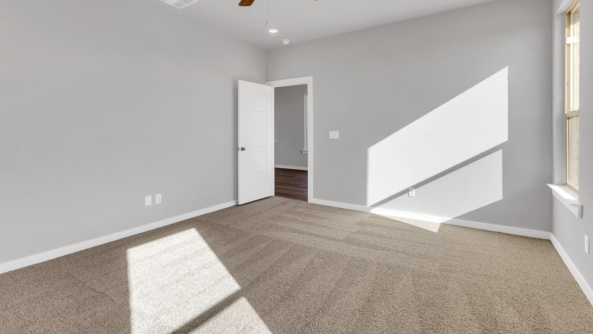 Primary room with attached walk in closet and private bathroom