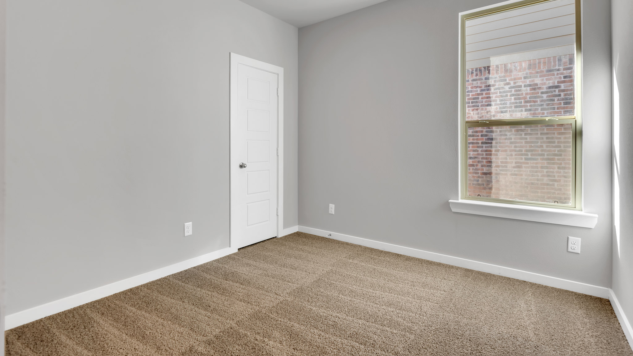 Bedroom 2 with side window and plush carpet floors