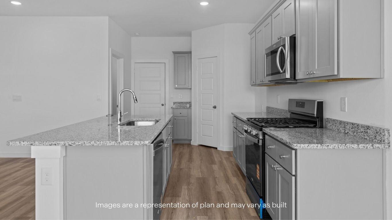 Open concept kitchen with stainless steel appliances, shaker style cabinets, and elevated finishes