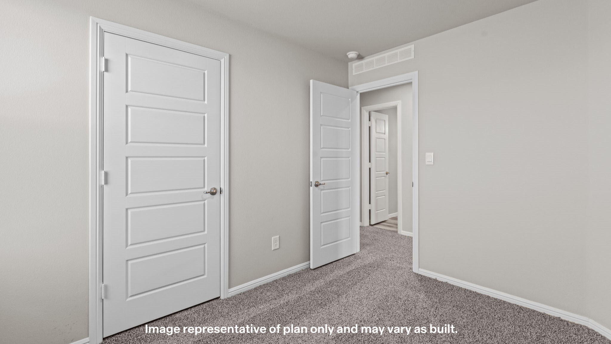 guest bedroom with spacious closet and plush carpet floors