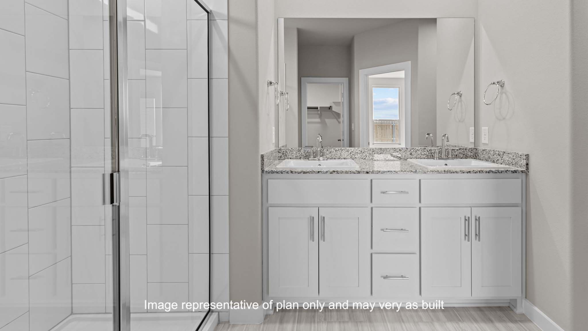 Private attached primary bathroom with built in vanity and luxurious shower