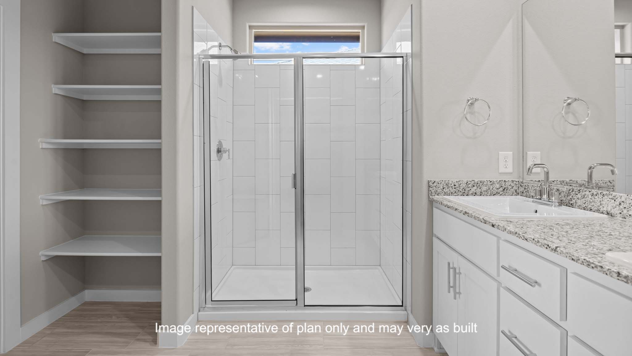 Private attached primary bathroom with built in vanity and luxurious shower