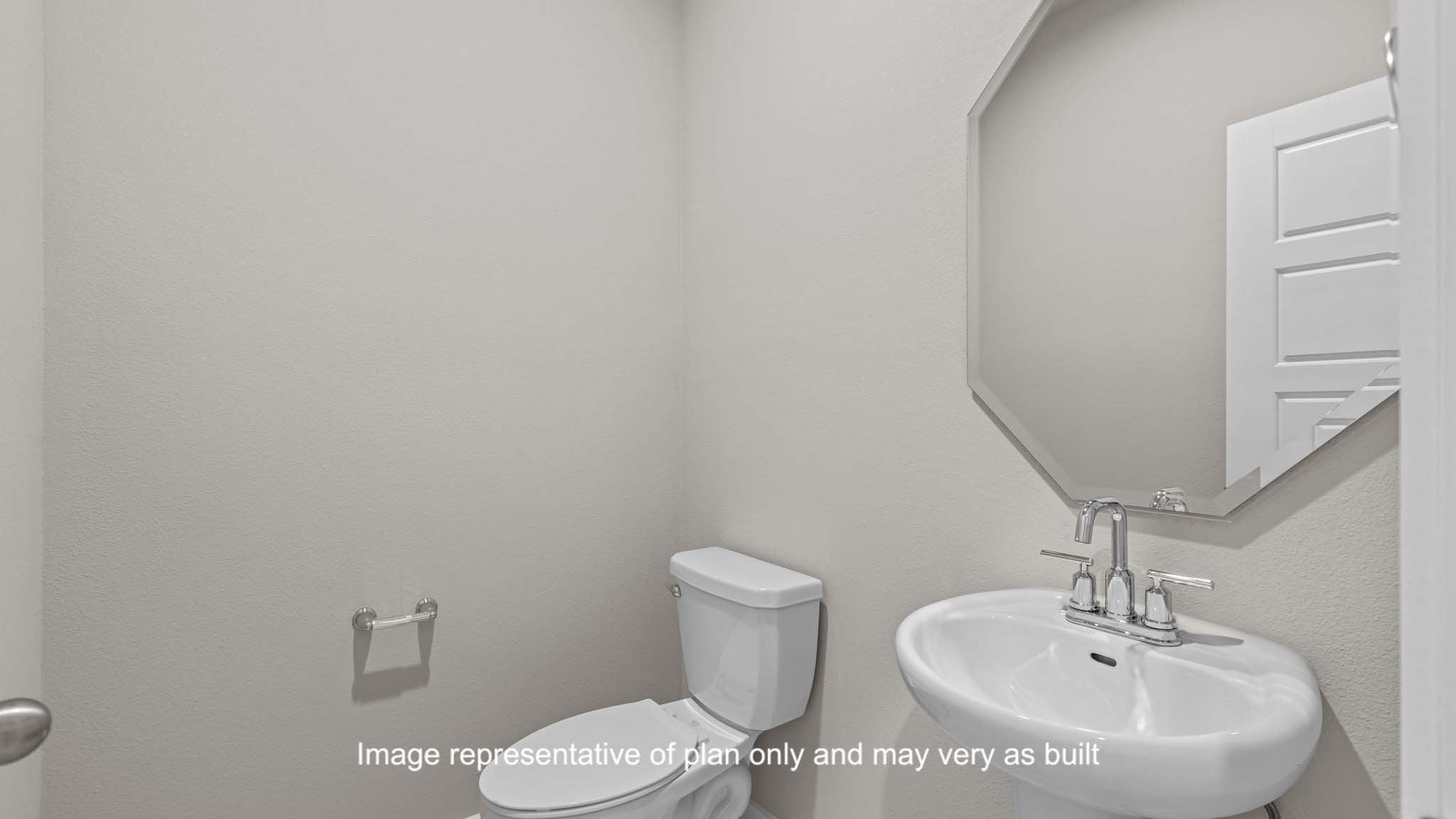 Half bathroom located before entering kitchen area