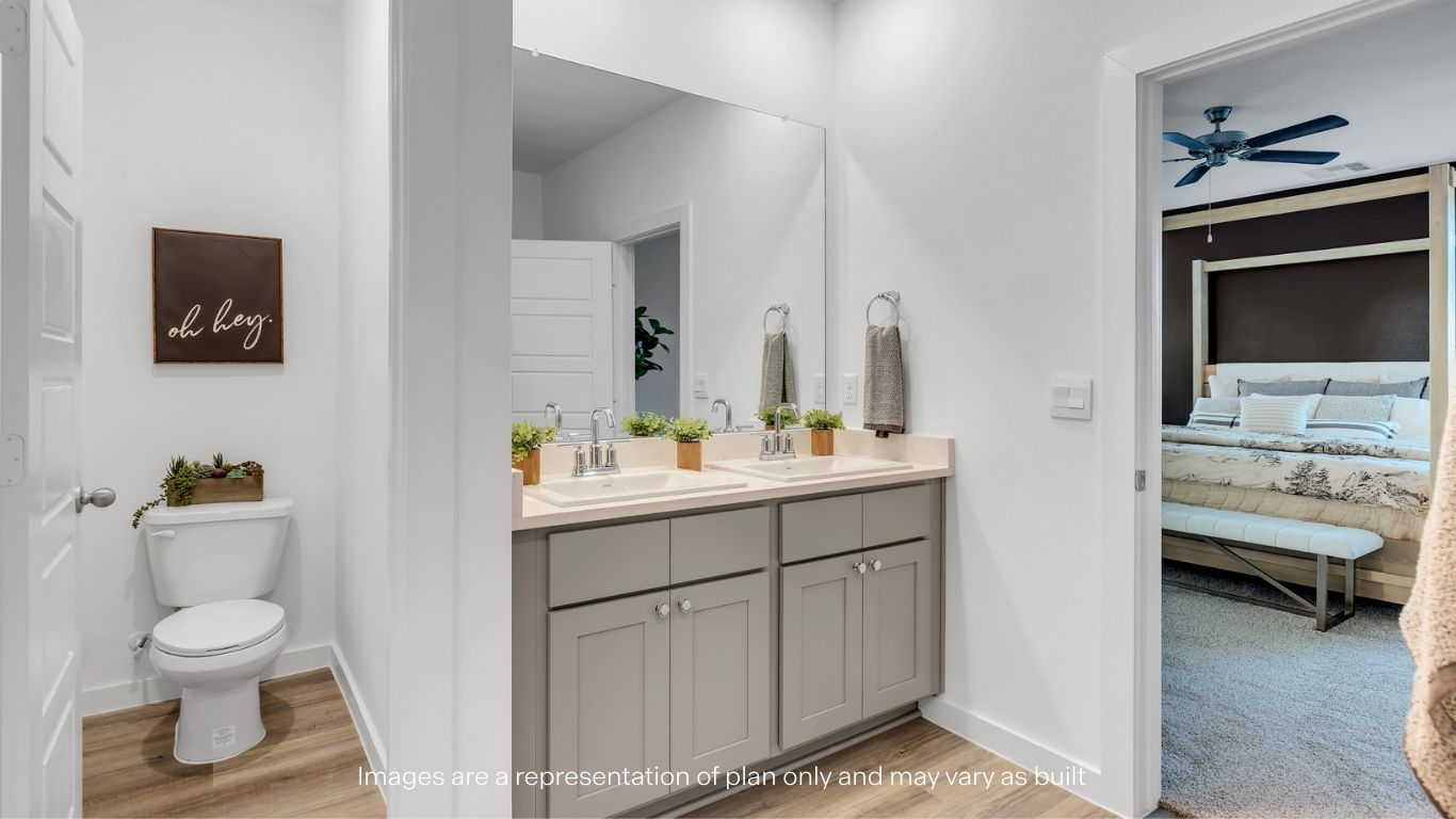 Private attached primary bathroom with built in vanity and luxurious shower