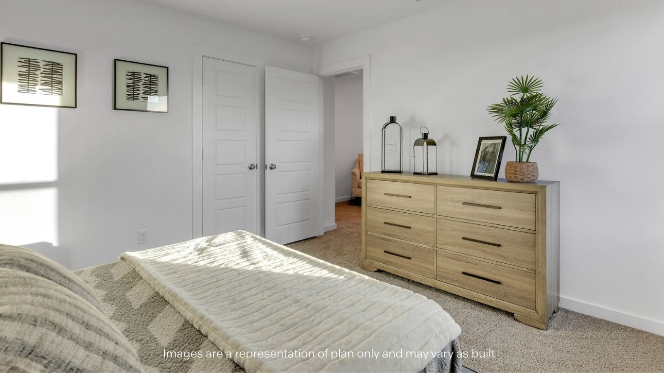 Guest bedroom 2 with side window and plush carpet floor