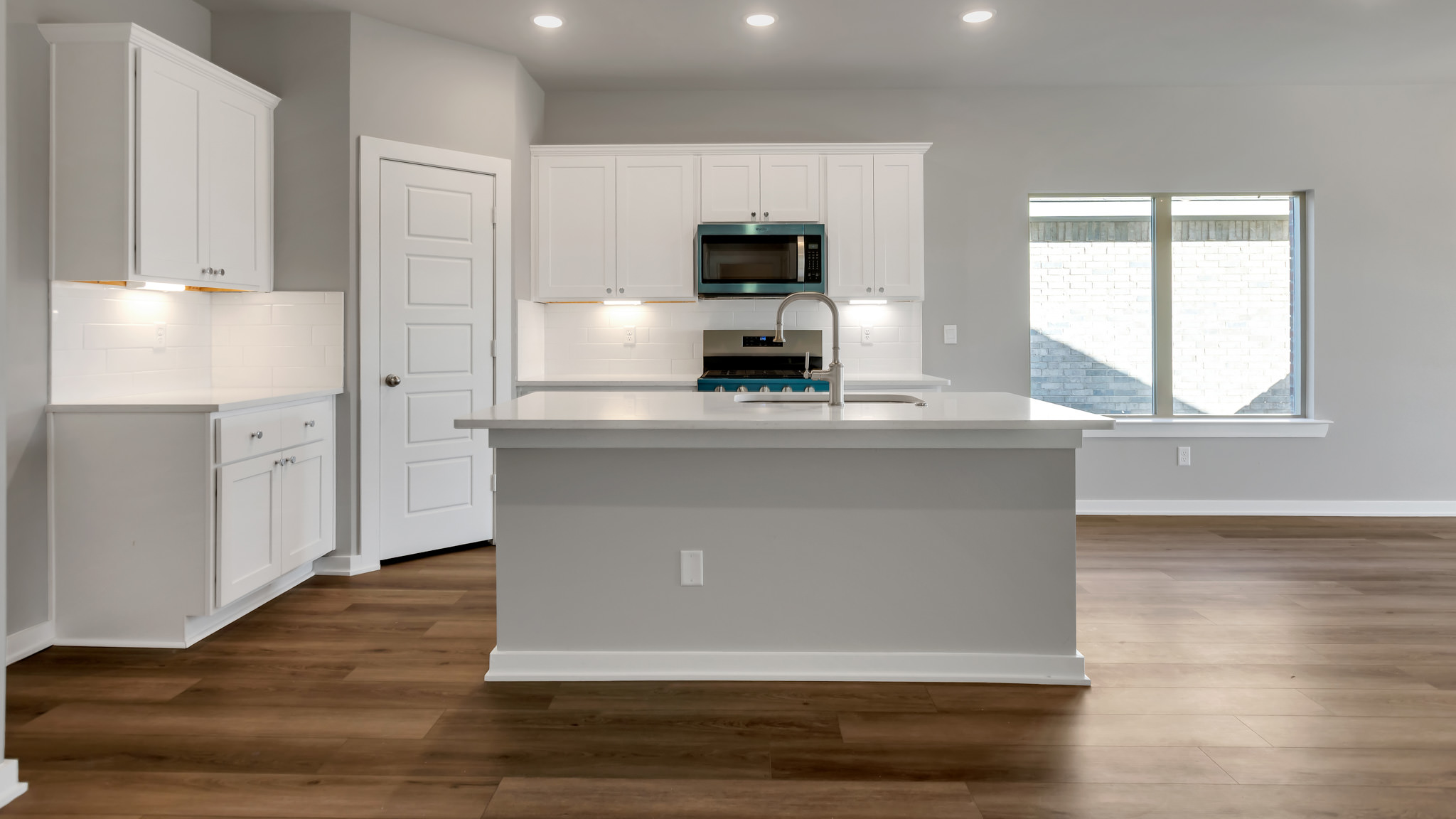 Spacious open concept kitchen with island and counter prep space