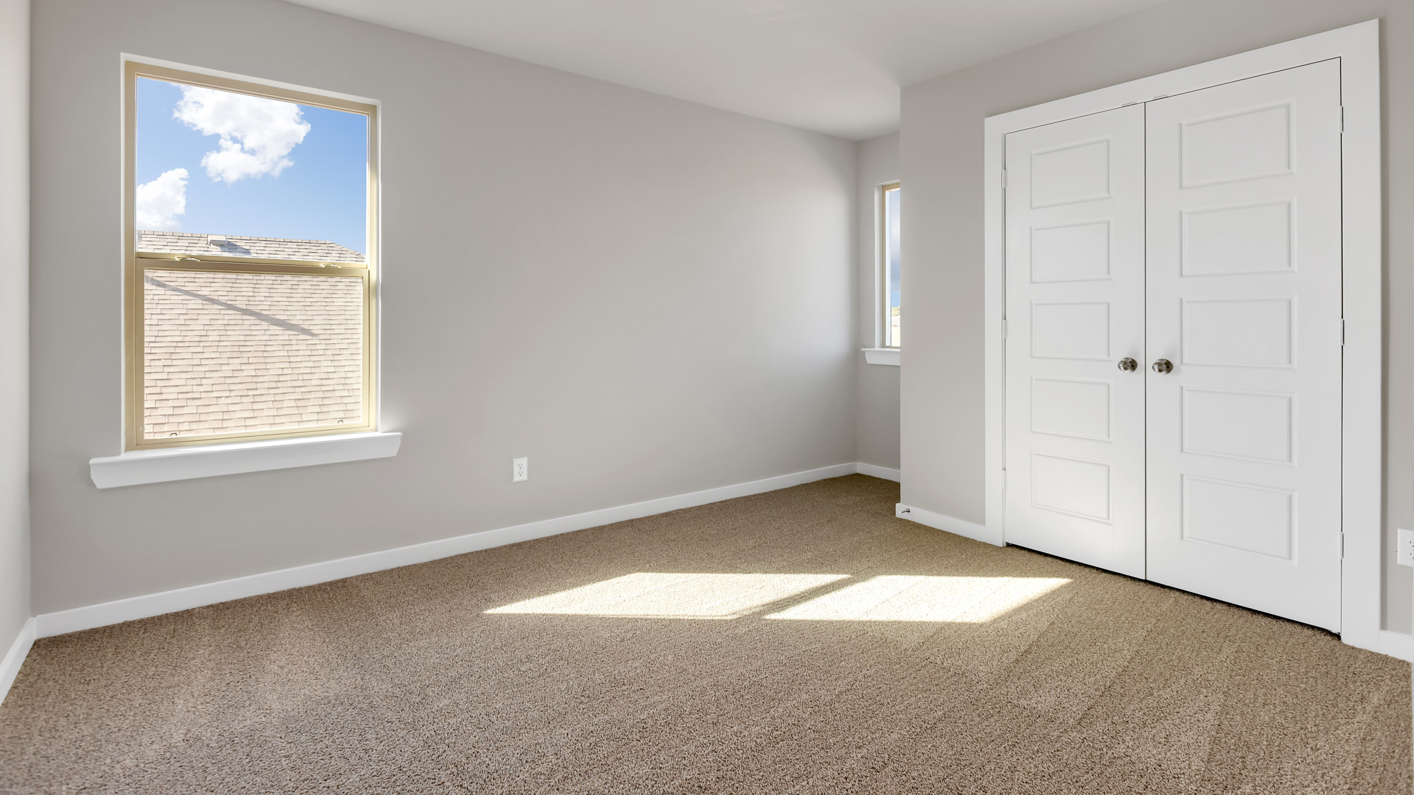 Upstairs Guest bedroom with plush carpet floors and spacious closet