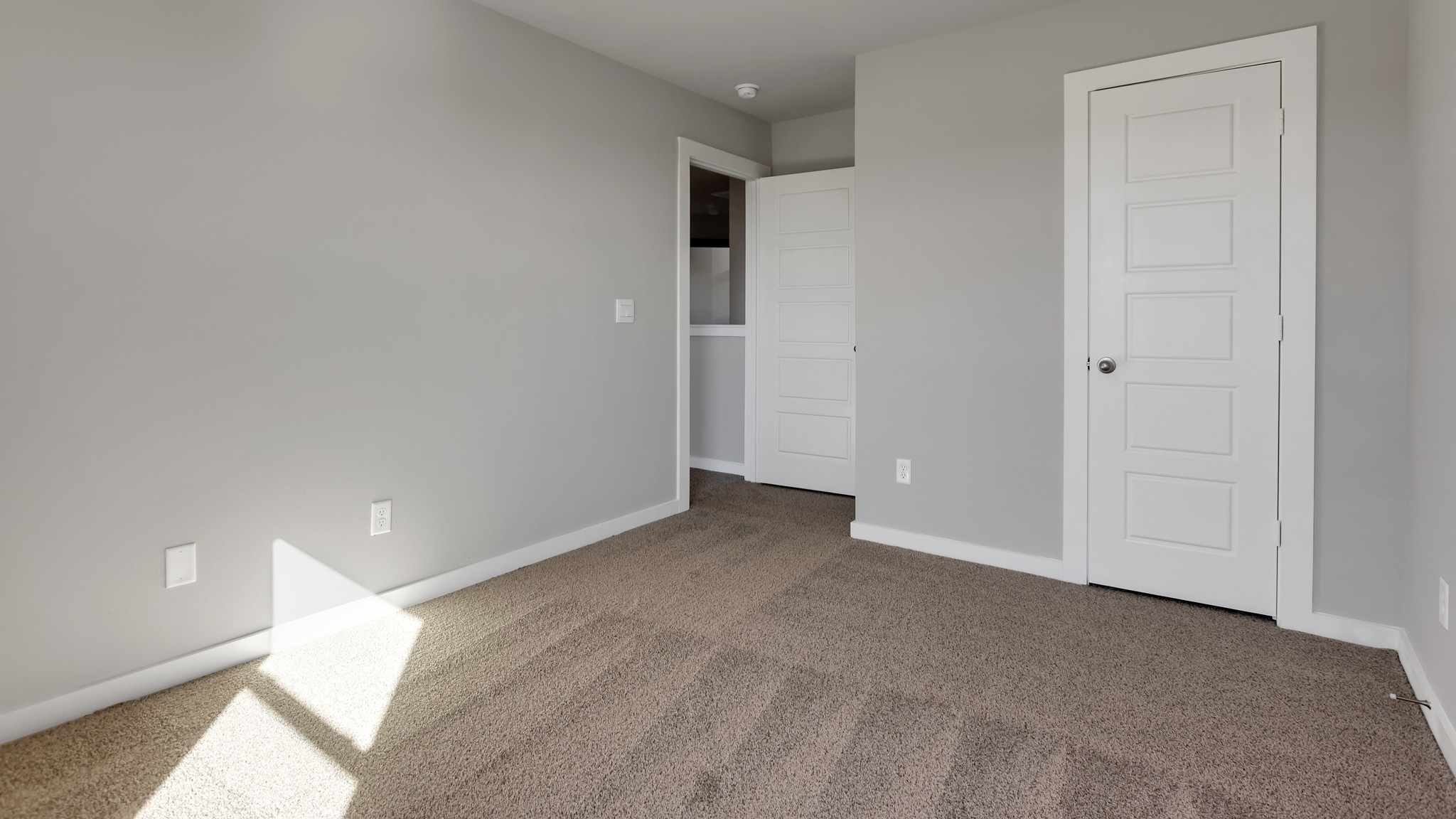 Upstairs Guest bedroom with plush carpet floors and spacious closet