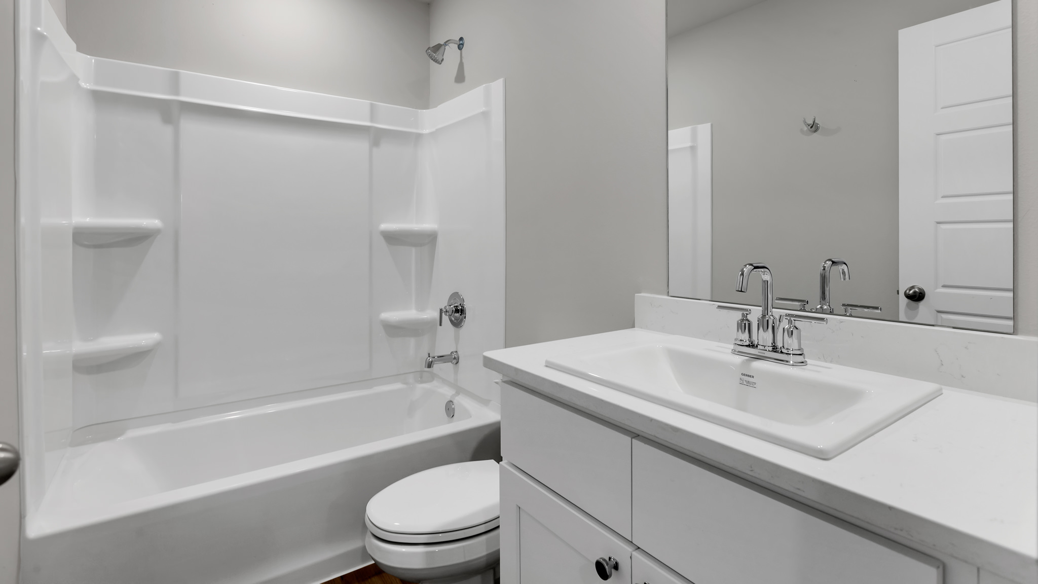 Guest bathroom with built in vanity and combination bathtub shower
