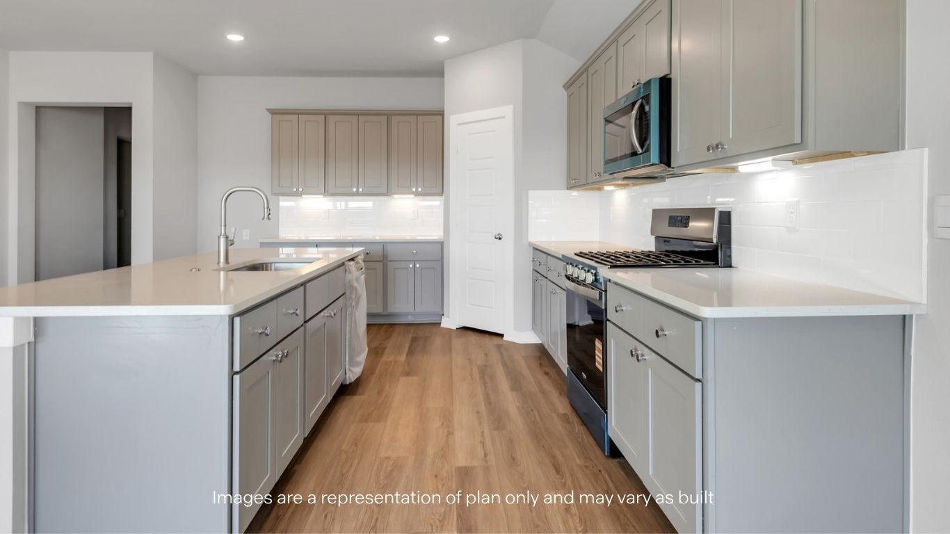 Open concept kitchen with stainless steel appliances, shaker style cabinets, and elevated finishes