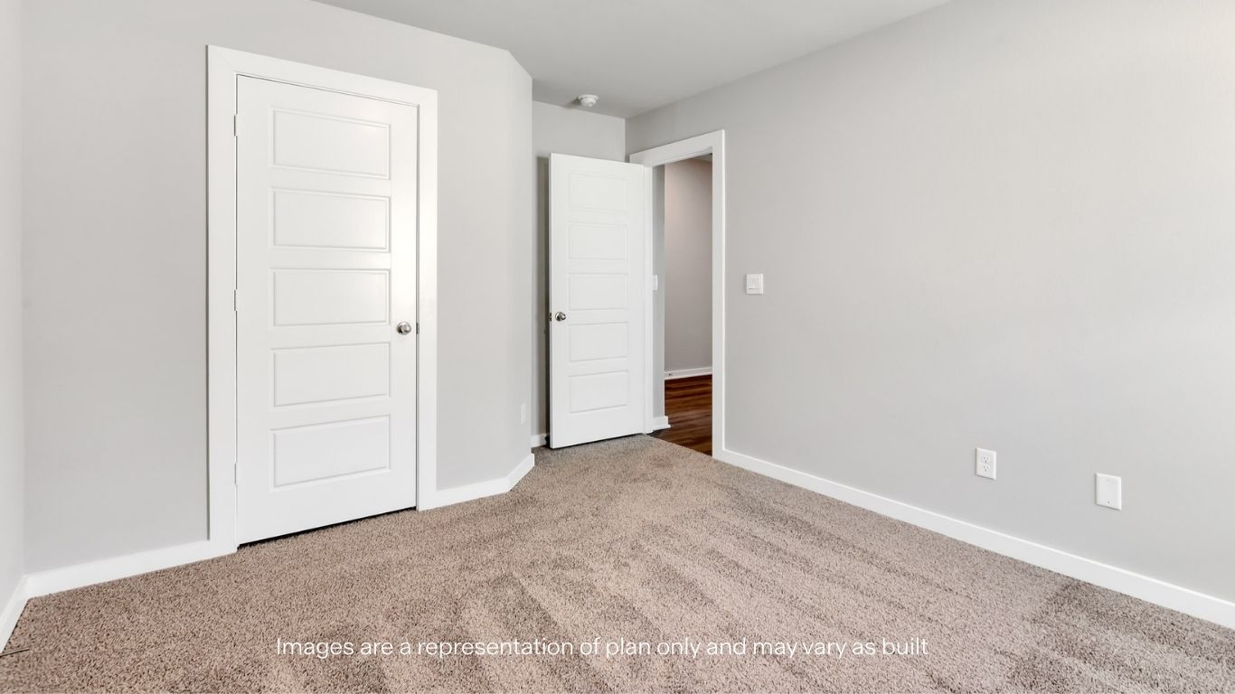 Guest bedroom 2 with side window and plush carpet floor