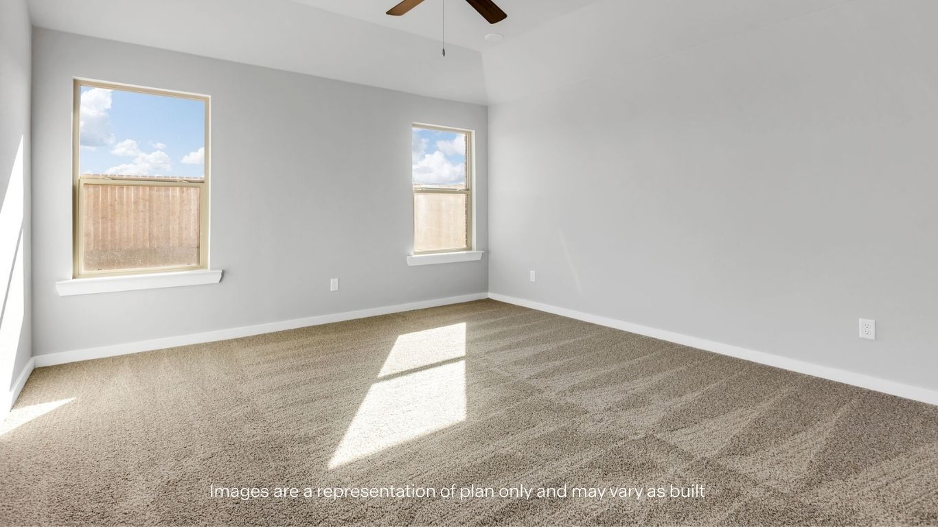 Primary bedroom with plush carpet floors and light allowing double windows
