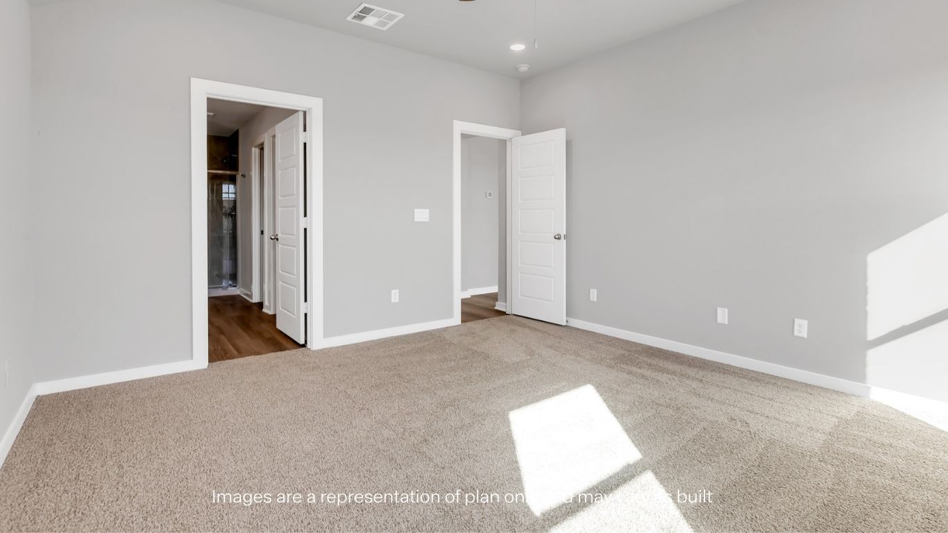 Primary bedroom with private attached bathroom and walk-in closet