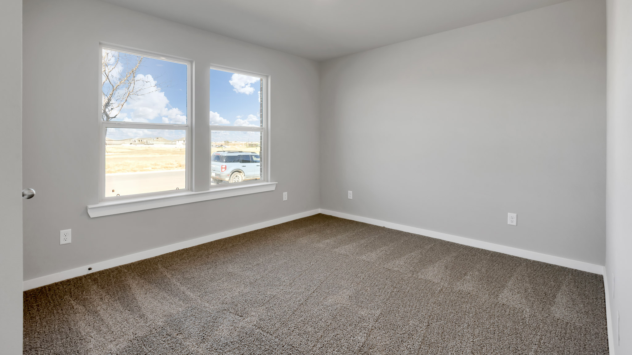 Guest bedroom 1 with front windows and ample natural light