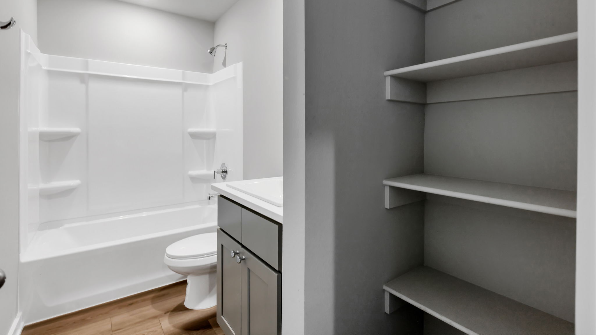 Guest bathroom with built in vanity and combination bathtub shower