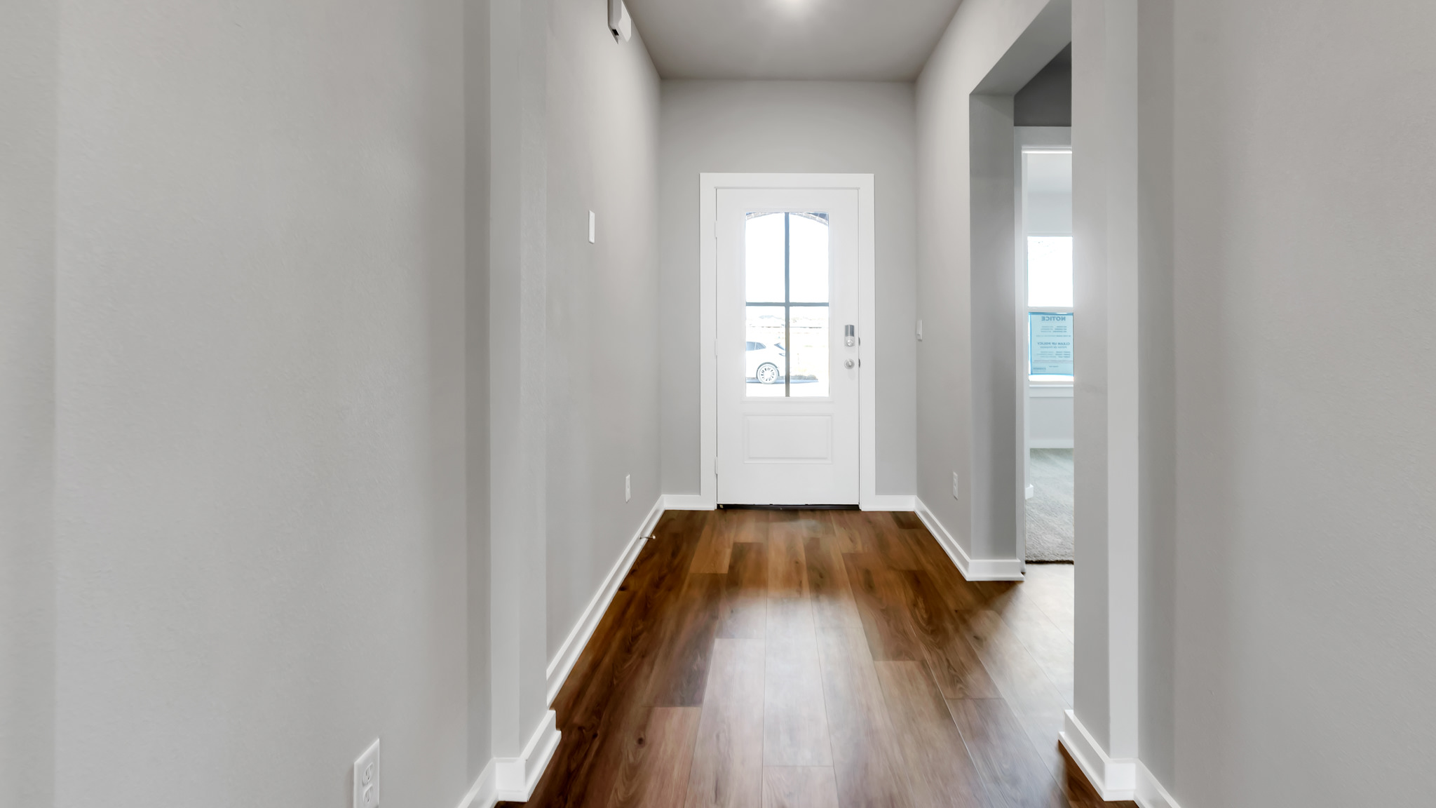 Spacious front foyer and entryway space with guest bedroom to the left
