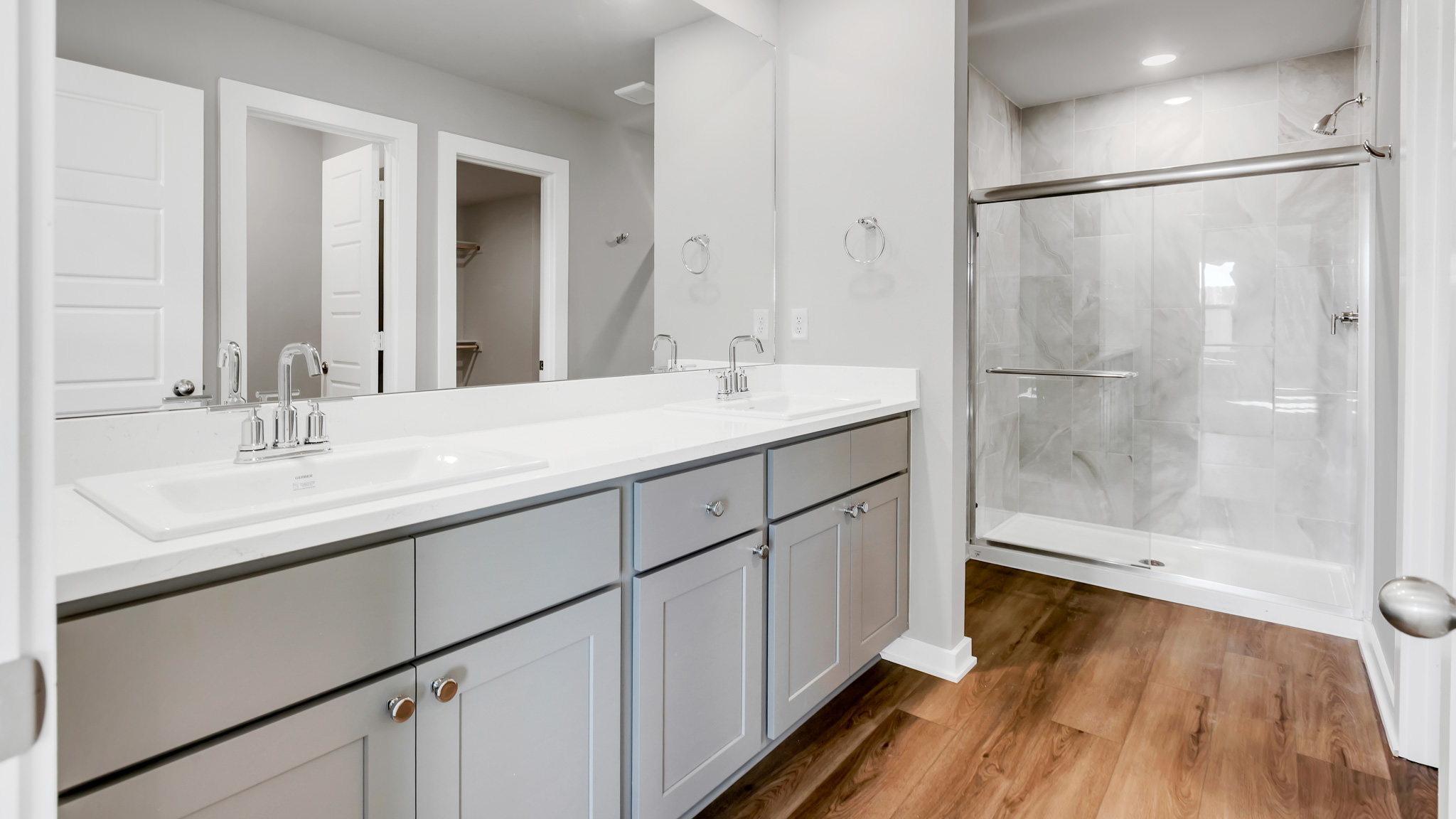 Private attached primary bathroom with built in vanity and luxurious shower