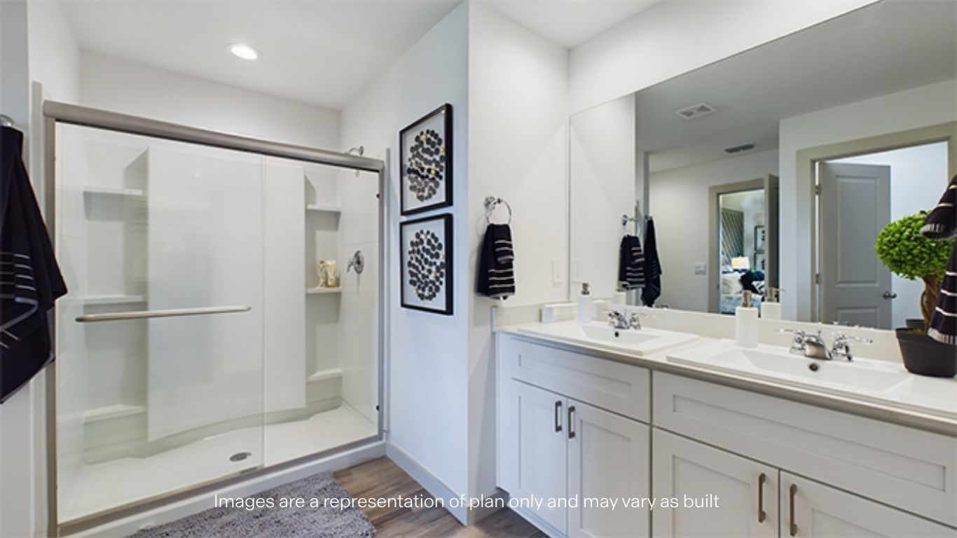 Private attached primary bathroom with built in vanity and luxurious shower