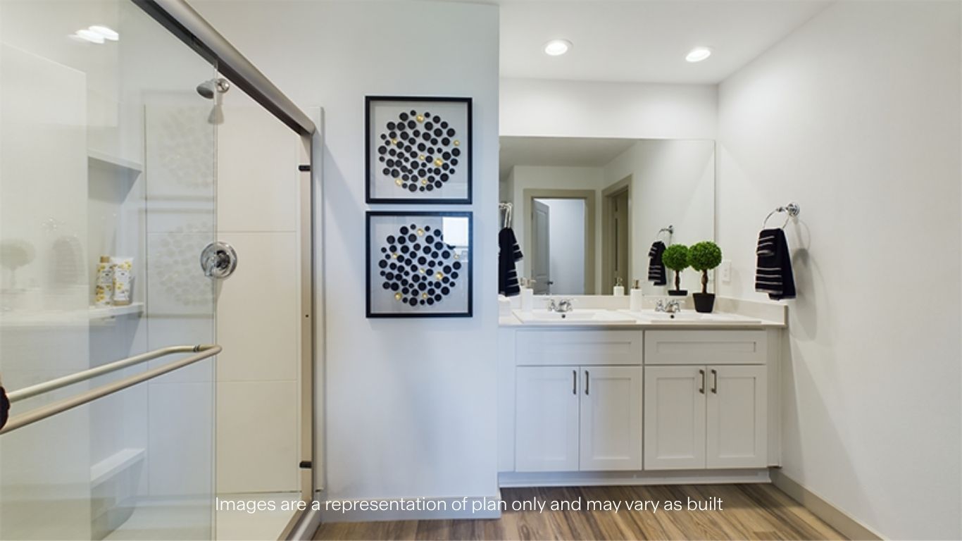 Primary bathroom with built in vanity and luxurious shower