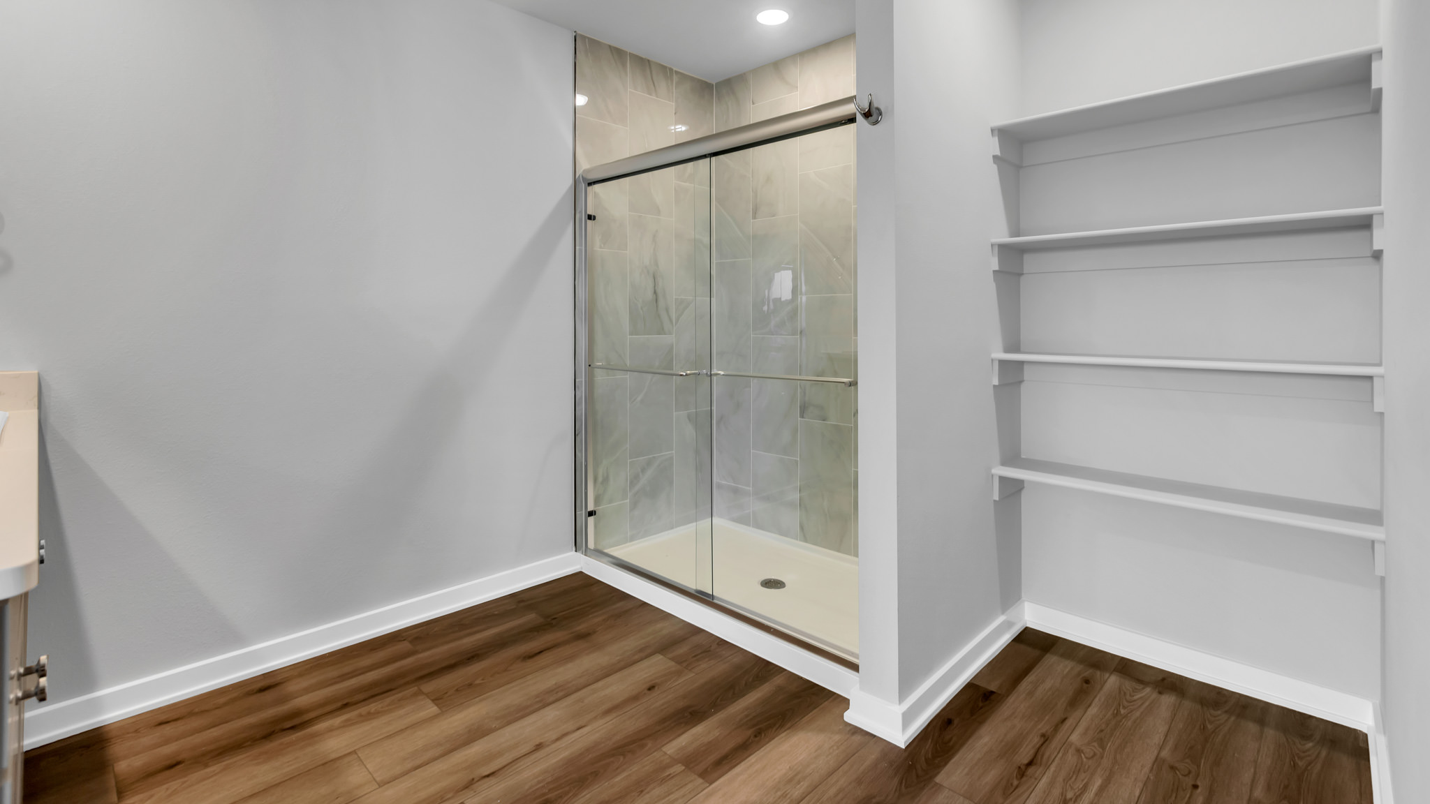 Primary bathroom with luxurious shower and built in storage