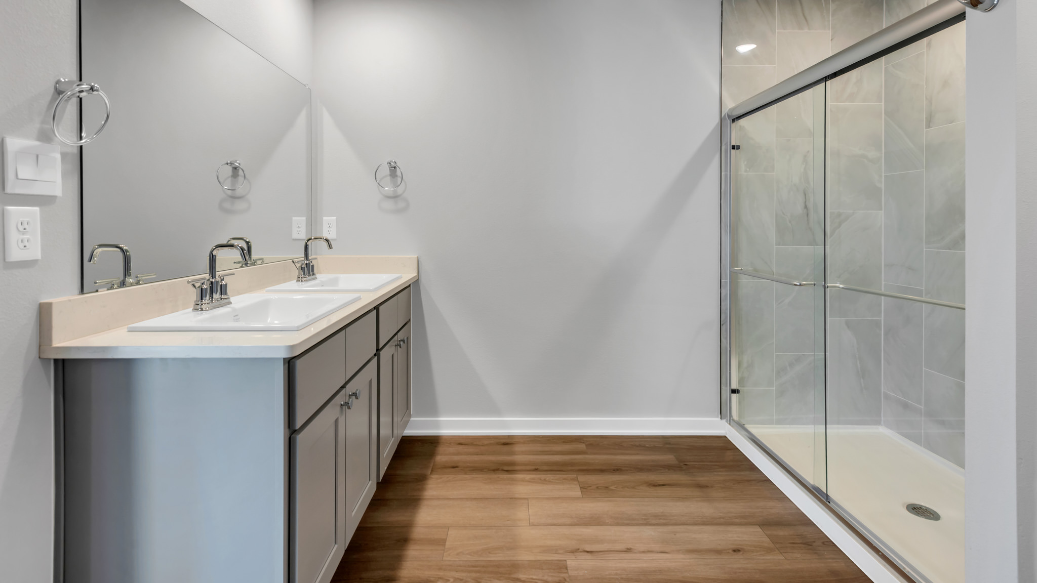 Primary bathroom with built in vanity and luxurious shower