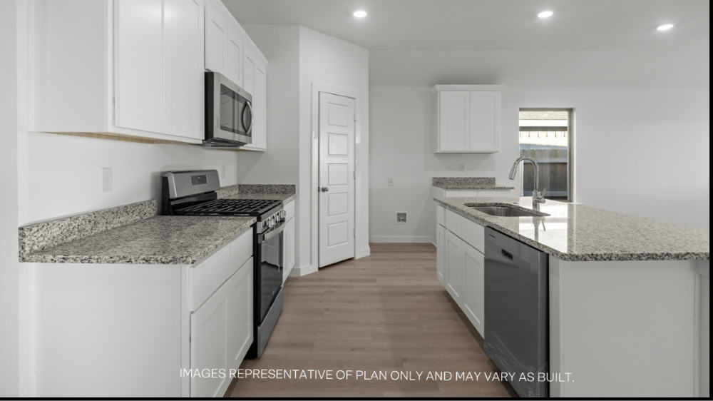 Open concept kitchen with stainless steel appliances, shaker style cabinets, and elevated finishes