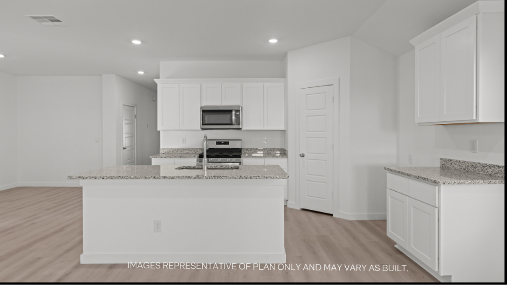 Spacious open concept kitchen with island and counter prep space